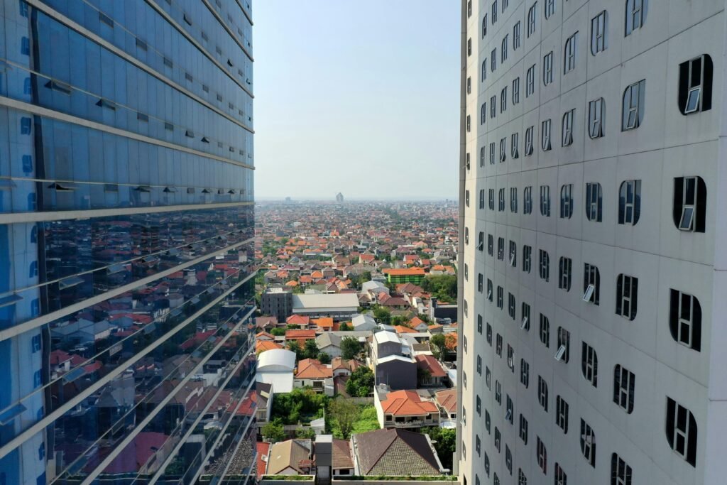 Explore the modern skyline of Surabaya between towering skyscrapers in this stunning aerial view.